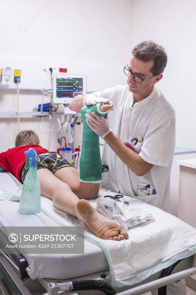 Doctor placing a plaster , emergency department of a private hospital .