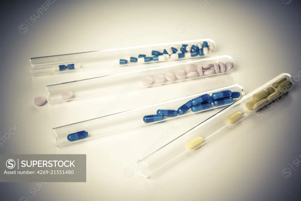 Capsules and pills in test tubes.