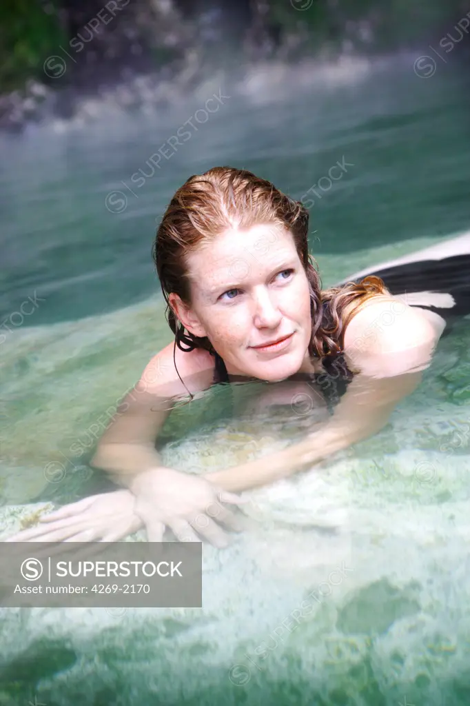 Woman bathing in geothermal hot springs.