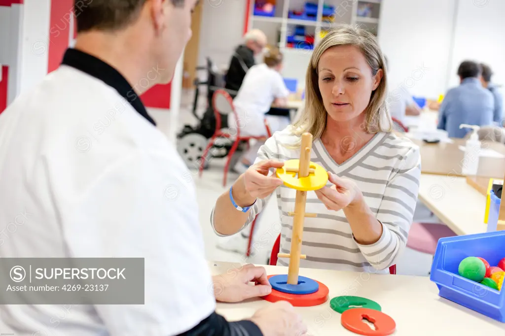 Functional rehabilitation of a hemiplegic woman. Occupational therapy session. Department of Physical Medicine and Rehabilitation, Limoges hospital, France.