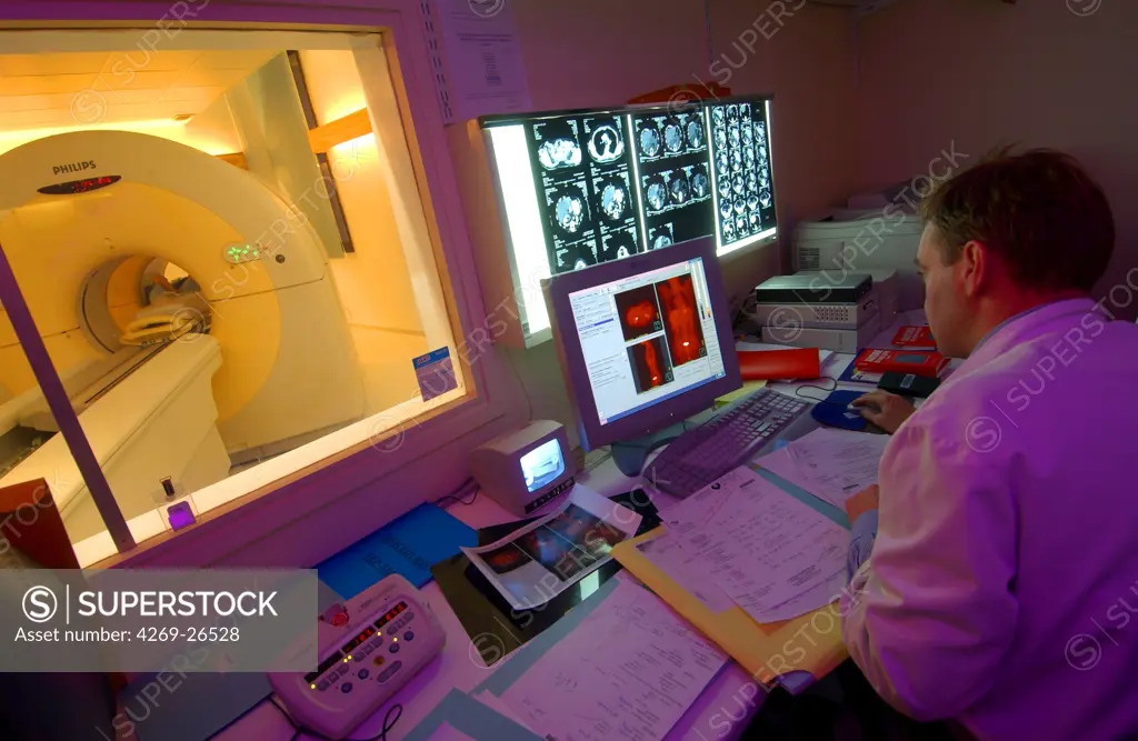 PET scan. Patient undergoing a positron emission tomography (PET) scan. A positon emission tomography exam allows the study of metabolic function of organs. It detects the presence of radioactive tracer molecules that have been injected into the patient's bloodstream and absorbed into the tissues.