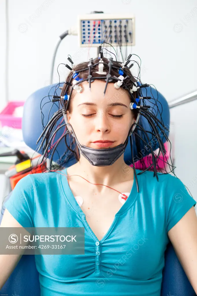 woman undergoing an electroencephalogram (EEG). Limoges hospital, France.