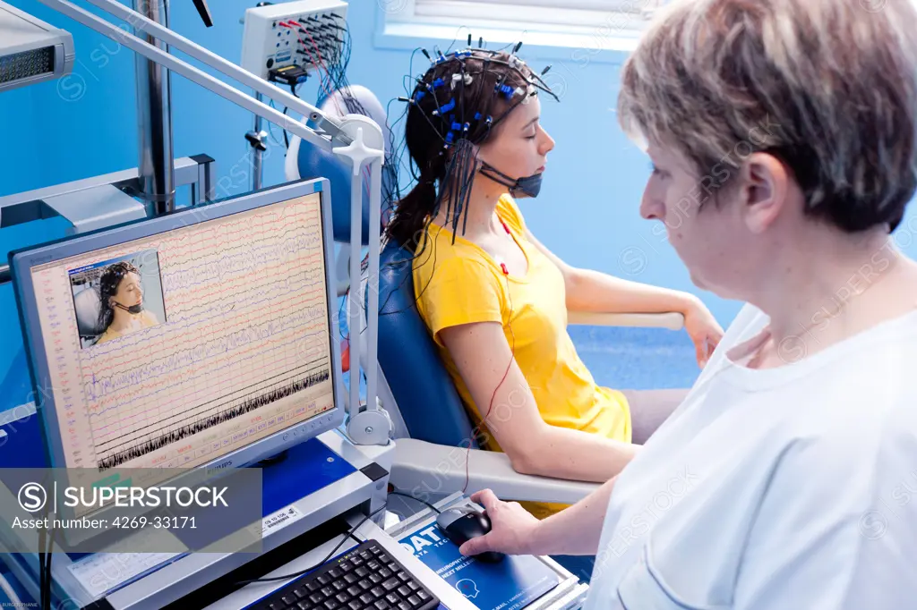 woman undergoing an electroencephalogram (EEG). Limoges hospital, France.