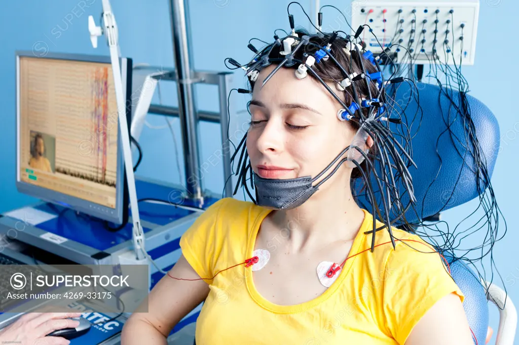 woman undergoing an electroencephalogram (EEG). Limoges hospital, France.