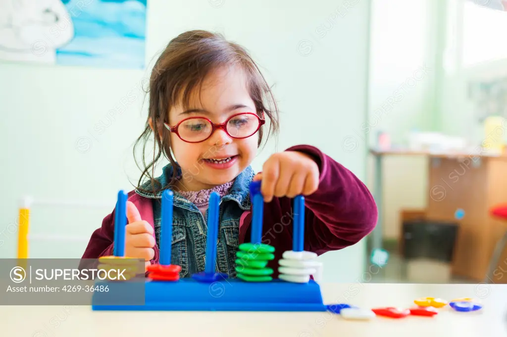 4 year old girl Down's syndrome during a session with a special education teacher.