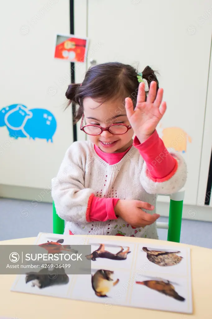 4 year old girl Down's syndrome during a session with a special education teacher.