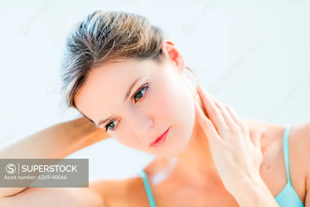 Woman suffering from neck pain.