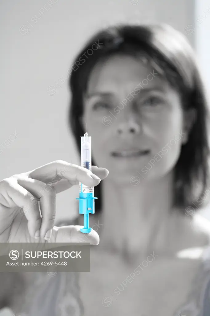 Woman injecting herself heparine, an anticoagulant drug used for prevention of venous thrombosis.