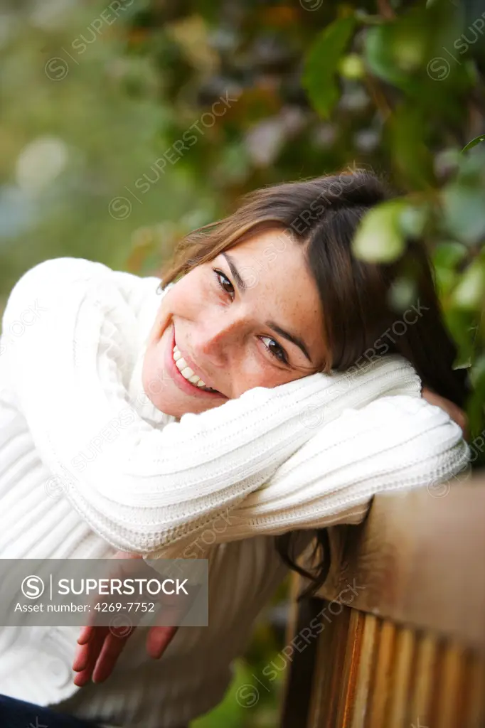 Woman sitting on a bench.