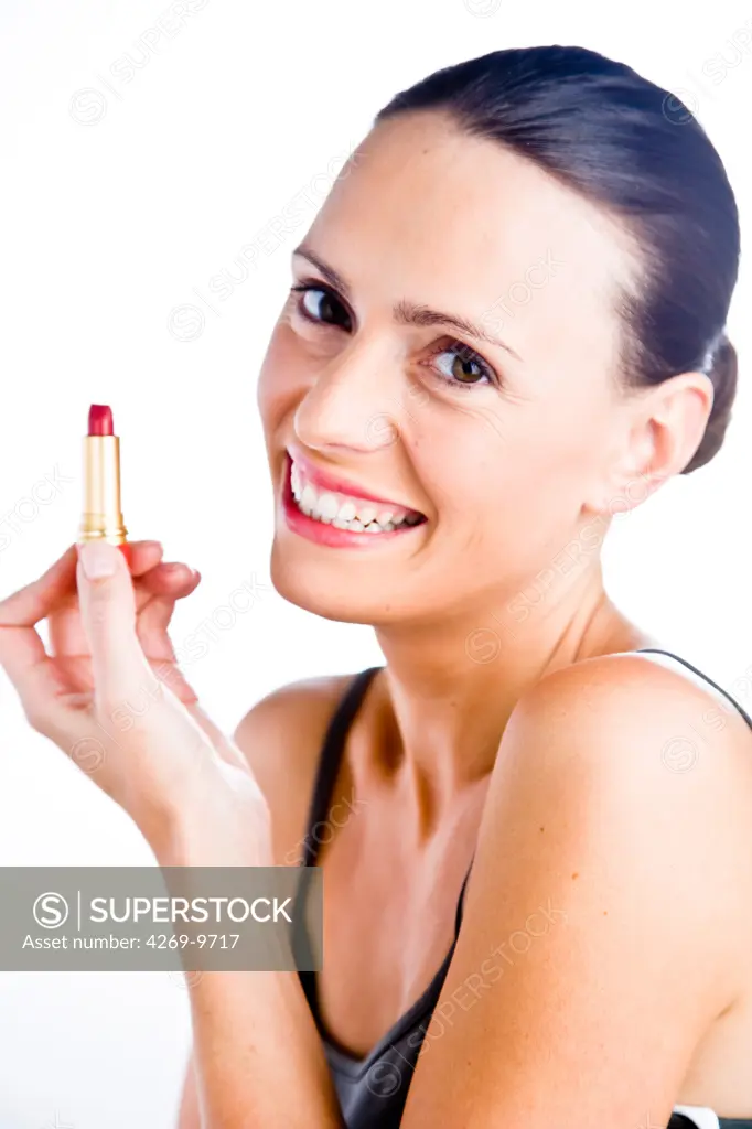 Woman applying lipstick.