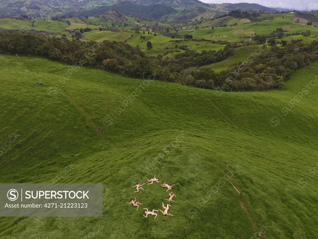 Group of nude women create a circle with their bodies in open nature. -  SuperStock