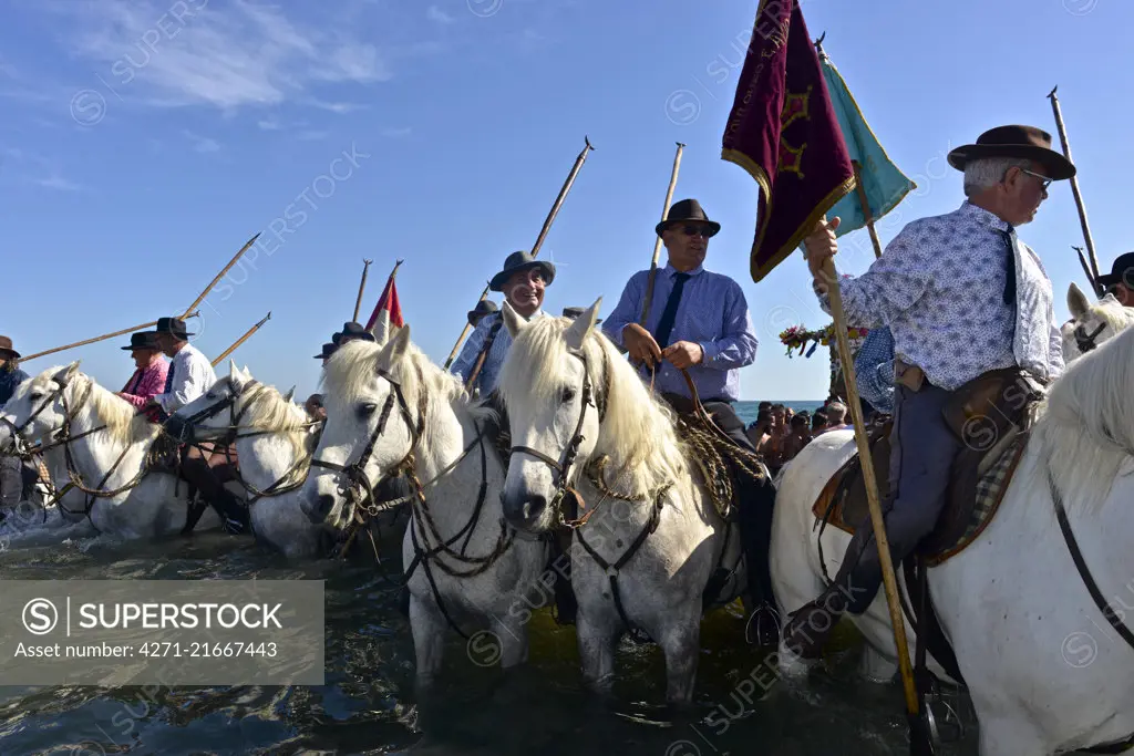 Annual Roma pilgrimage at Saintes-Maries-de-la-Mer. The statue of Sara, carried by the Gypsies to the sea, symbolizes the waiting for and welcome of the Saints Mary Jacobe and Mary Salome. Gardians, the local bull shepherds, wait on horseback for the beginning of the procession and accompany the sculpture of Sara the Black all the way to the sea.