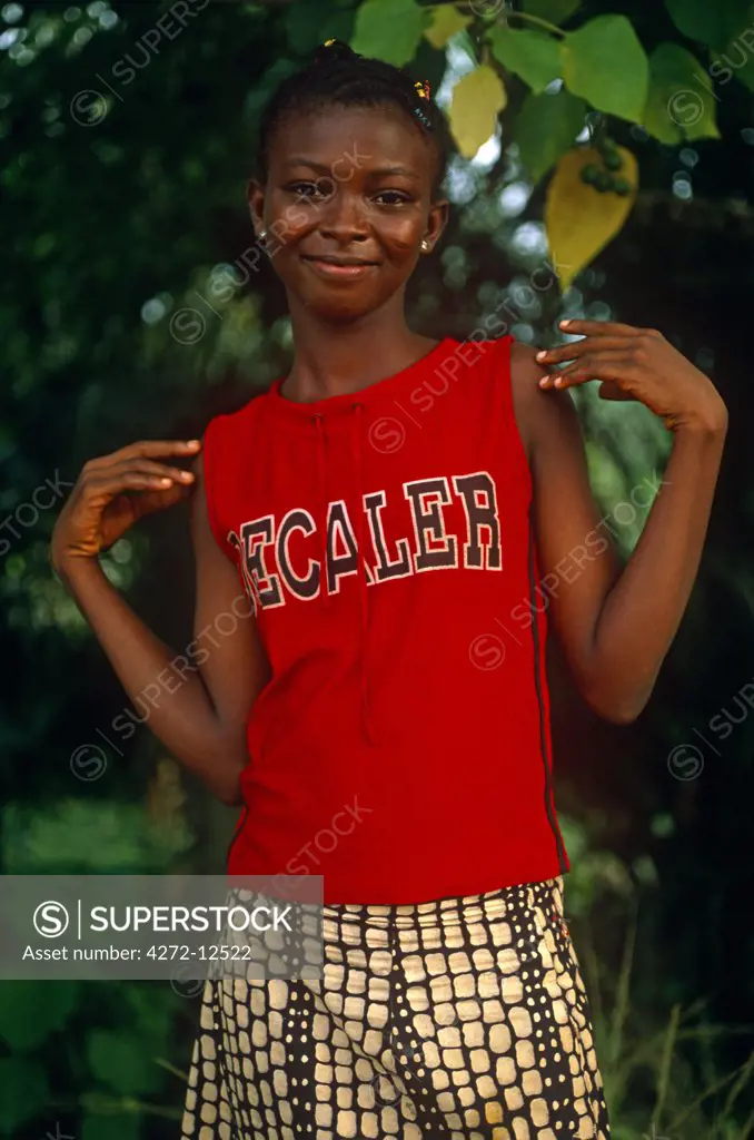 Ghana, Central region, Cape Coast. Girl in western clothes.