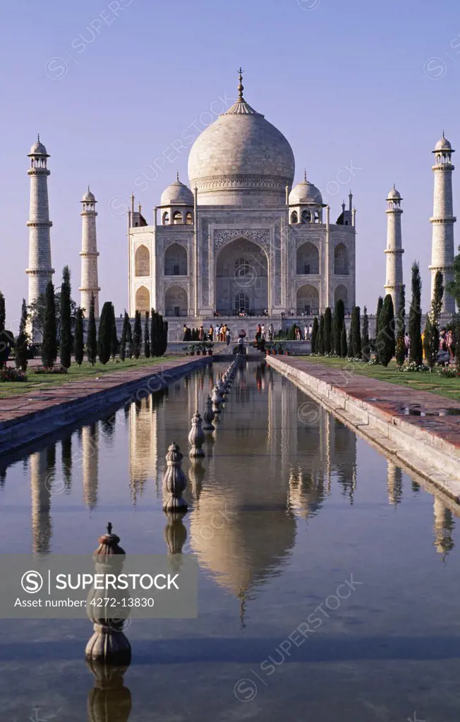 Frontal view of the Taj Mahal, Agra. The Taj Mahal was built by a Muslim, Emperor Shah Jahan in the memory of his dear wife and queen Mumtaz Mahal. It is an elegy in marble or some say an expression of a dream. Taj Mahal, meaning Crown Palace, is a Mausoleum that houses the grave of queen Mumtaz Mahal at the lower chamber.