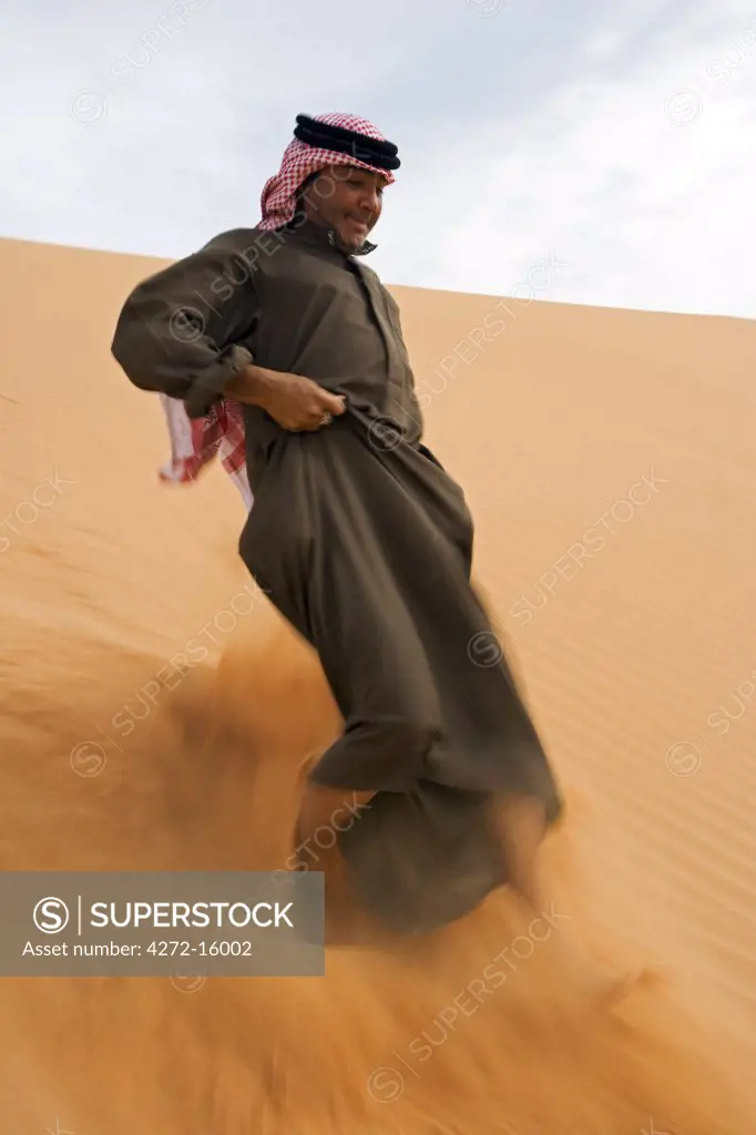 Jordan, Shara Mountains. A local Beduin guide walking amongst the sand dunes that mark the edge of the Shara Mountains. (MR)