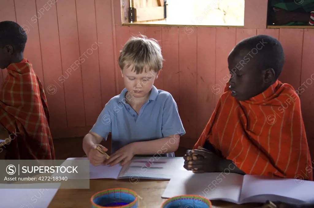 Kenya, Laikipia, Ol Malo. Young visitors join Samburu children in their lessons at Ol Malo school