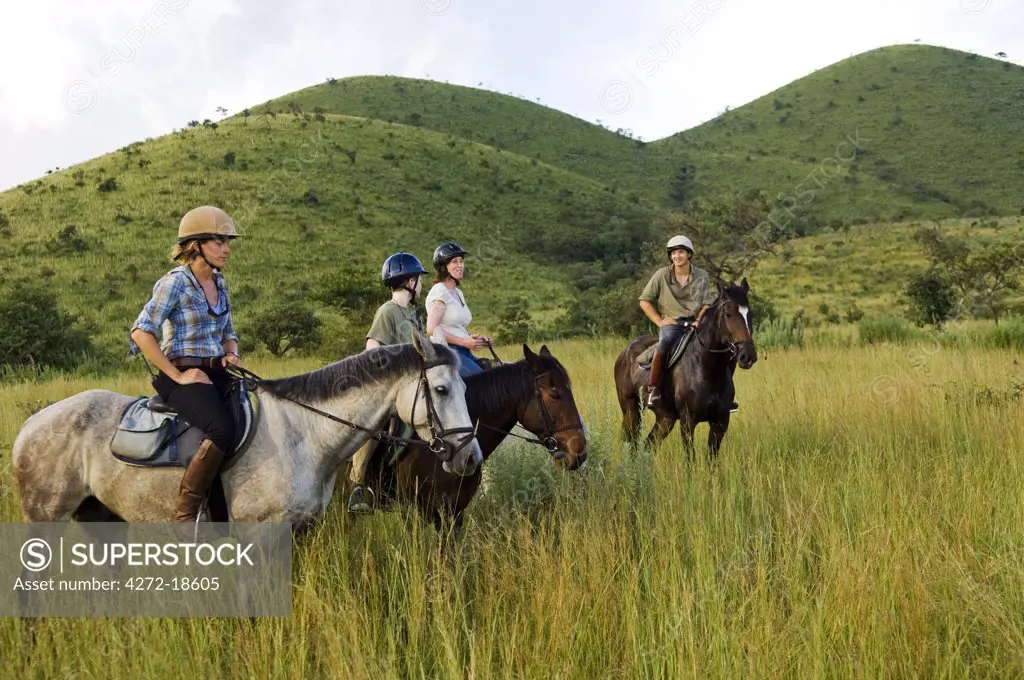 Kenya, Chyulu Hills, Ol Donyo Wuas.  A family on a horse riding safari up in the Chyulu Hills.  (MR)