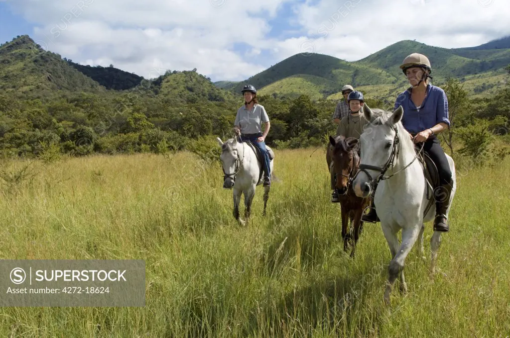 Kenya, Chyulu Hills, Ol Donyo Wuas.  Family on a riding safari with Ride Africa in the Chyulu Hills. (MR)