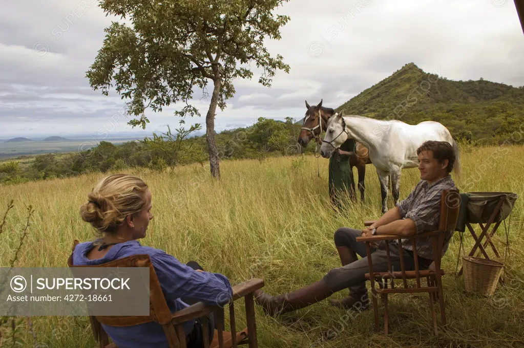 Kenya, Chyulu Hills, Ol Donyo Wuas. Couple on a horse riding safari with Ride Africa in the Chyulu Hills (MR)