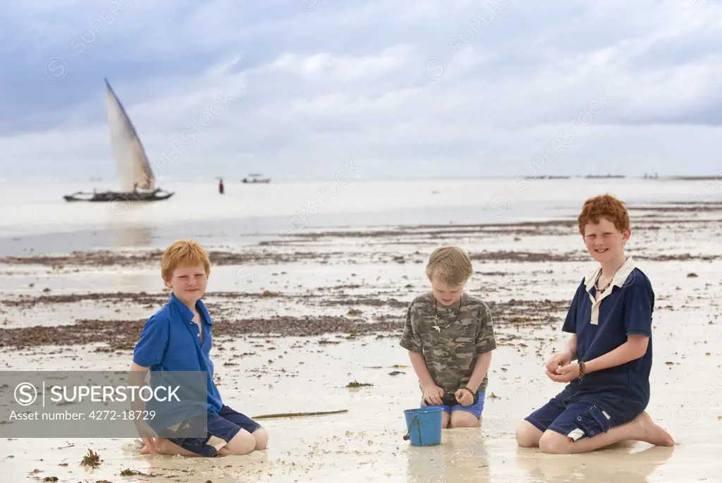 Kenya, Coast, Diani Beach.  Children play on the beach. (MR)