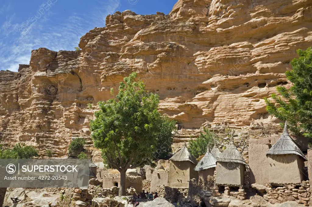 Mali, Dogon Country, Tereli. The typical Dogon village of Tereli situated among rocks at the base of the 120-mile-long Bandiagara escarpment. Dwellings have flat roofs while granaries to store millet have pitched thatched roofs.