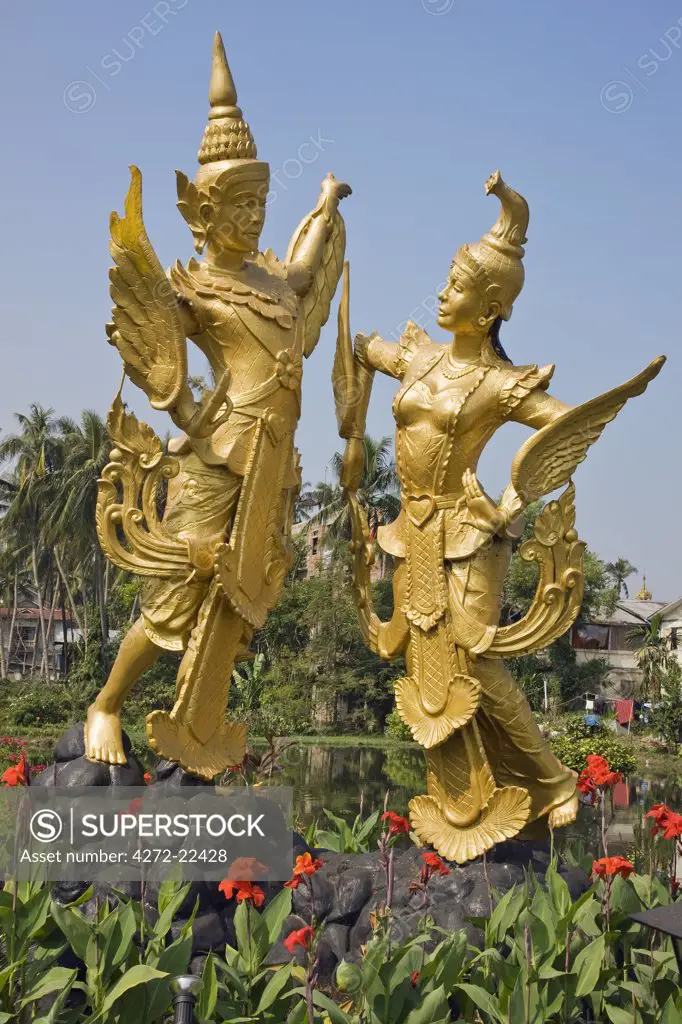 Myanmar, Burma, Yangon. A statue of the mythical creatures Kannari and Kannara - half human, half bird - in the middle of Myananda Lake.