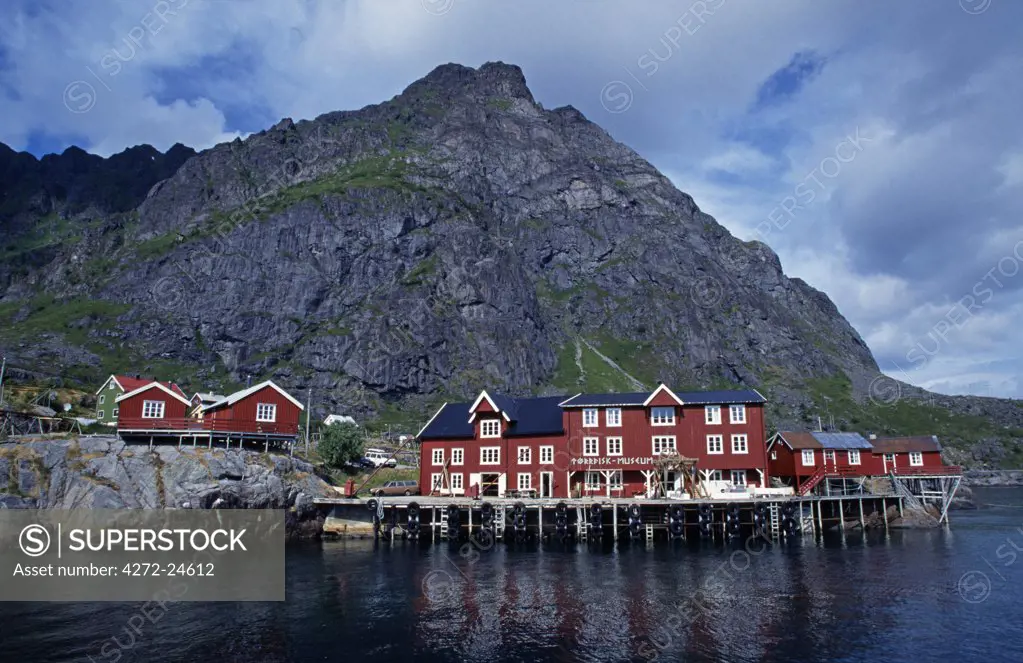 Norway, Lofoten Islands, Reine. View of waterfront buildings and surrounding scenery.