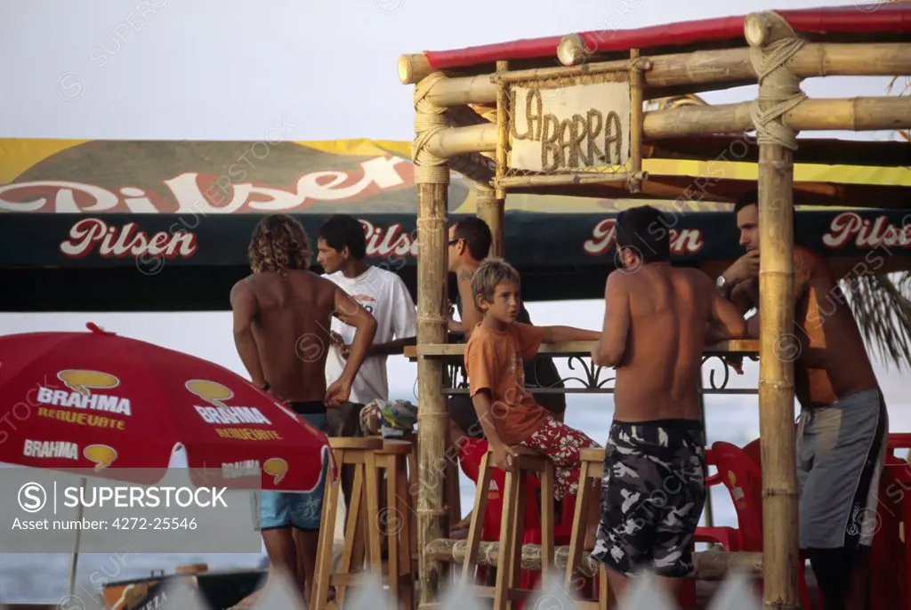 Tourists relax at a beachside bar at the resort town of Mancora, in northern Peru.