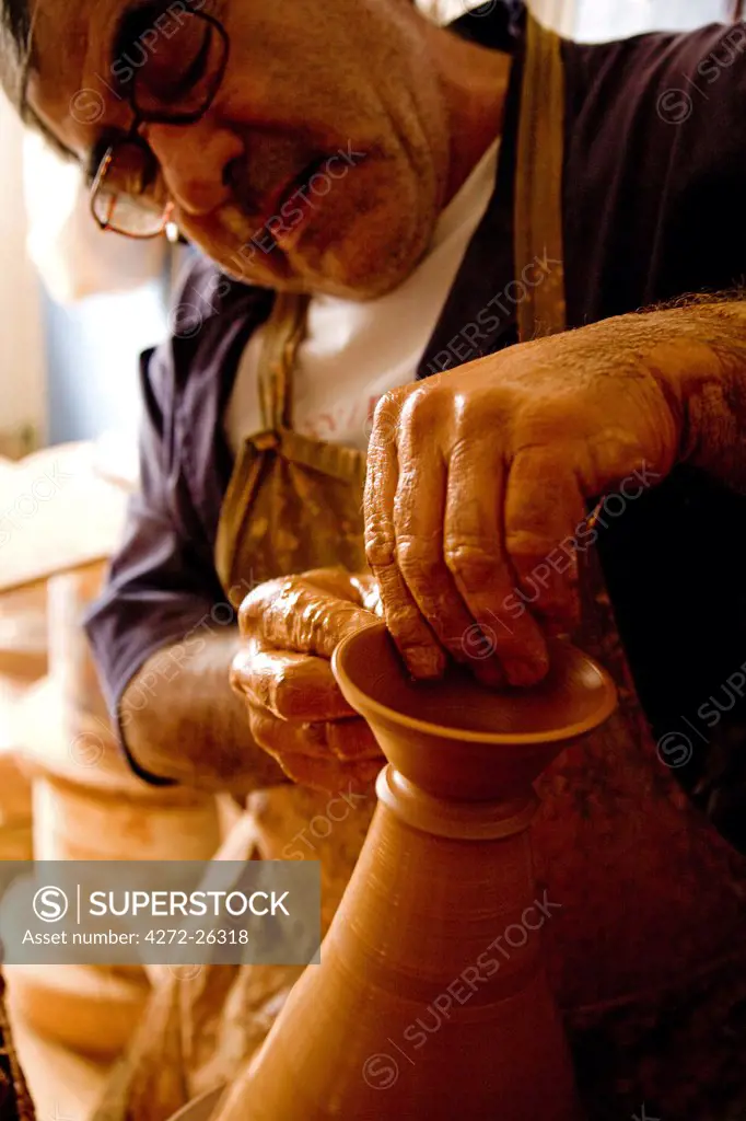 Portugal, Alentejo, Estremoz. A Portuguese potter at work in his studio in the Alentejo region of Portugal which is famous for its ceramics.