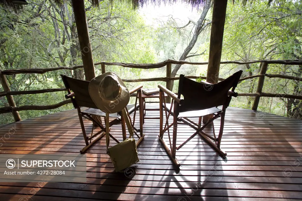 South Africa; North West Province; Madikwe Game Reserve. Canvas safari chairs on the private balcony of a cottage at Jaci's Safari Lodge.