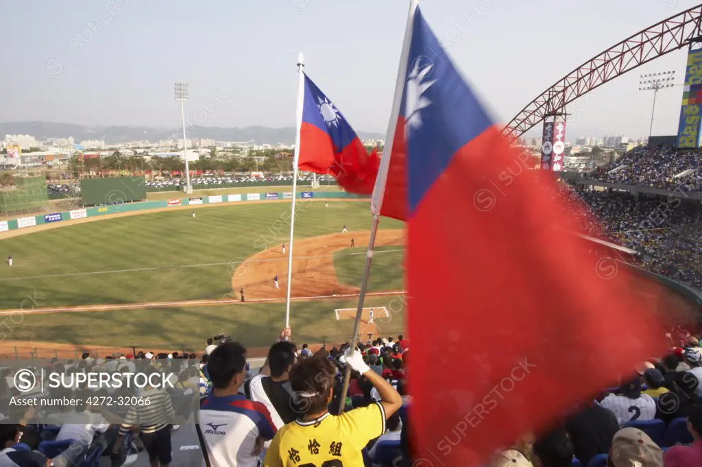 Man holding Taiwanese flag at baseball game, Taichung, Taiwan