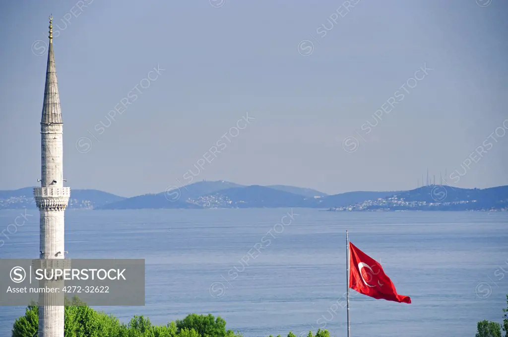 Turkey, Istanbul. Turkish flag and minaret.Blue Mosque