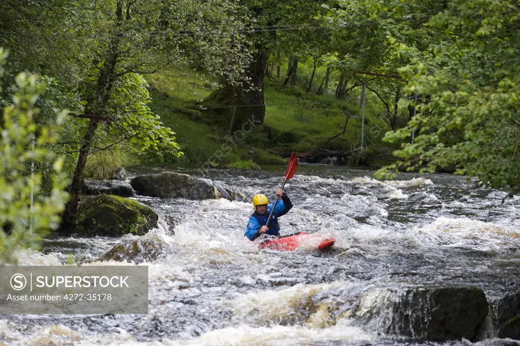 Wales, Gwynedd, Bala. White water kayaking on the Tryweryn River at the National Whitewater Centre