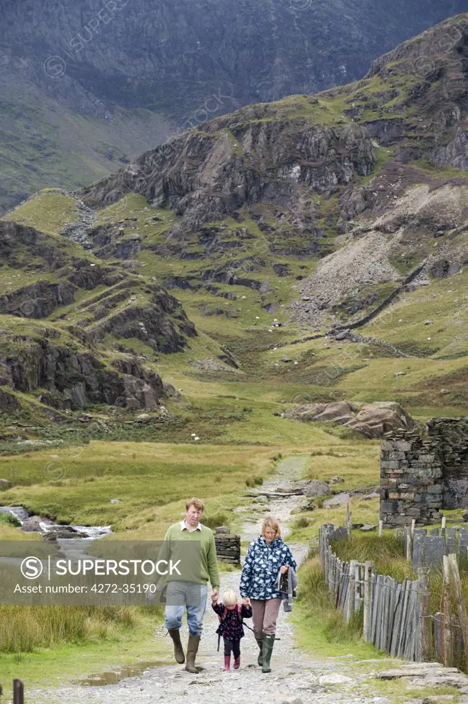 Wales, Conwy, Snowdonia. A family walking in Cwm Llan along the Watkin Path one of the routes up Snowdon.