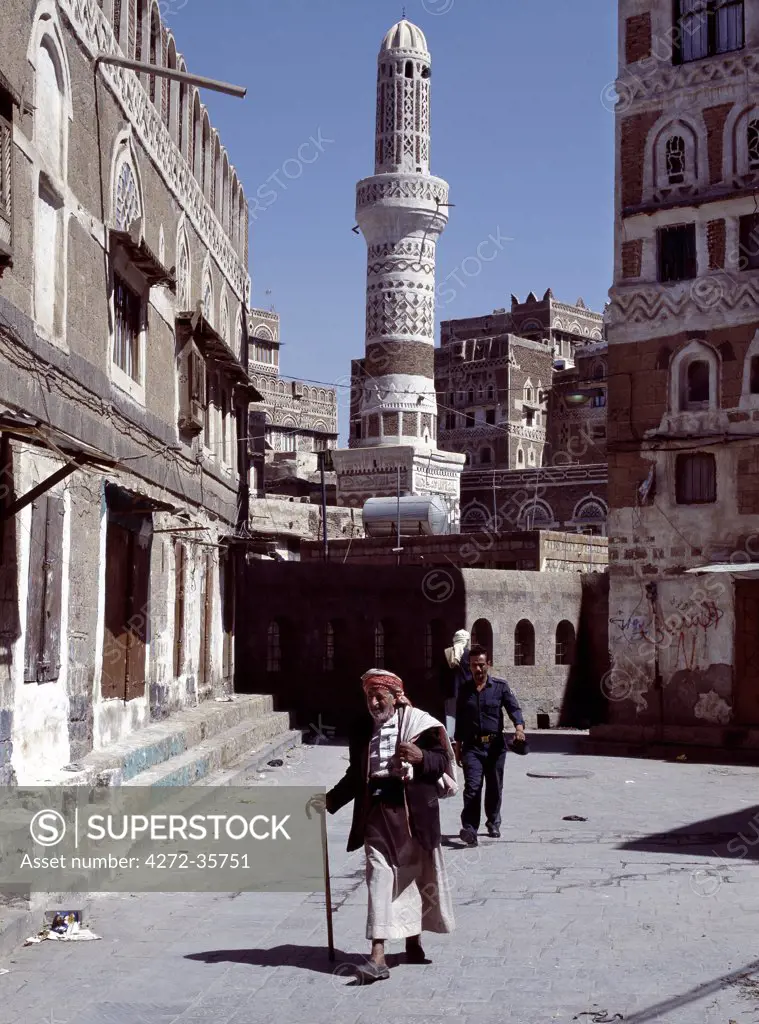 An old man walks along a street in Old Sanaa. Surrounded by a massive 20 to 30 foot high wall, old Sanaa is one of the worlds oldest inhabited cities. Several stone and brick buildings date back to the 11th Century AD, many are over 400 years old.