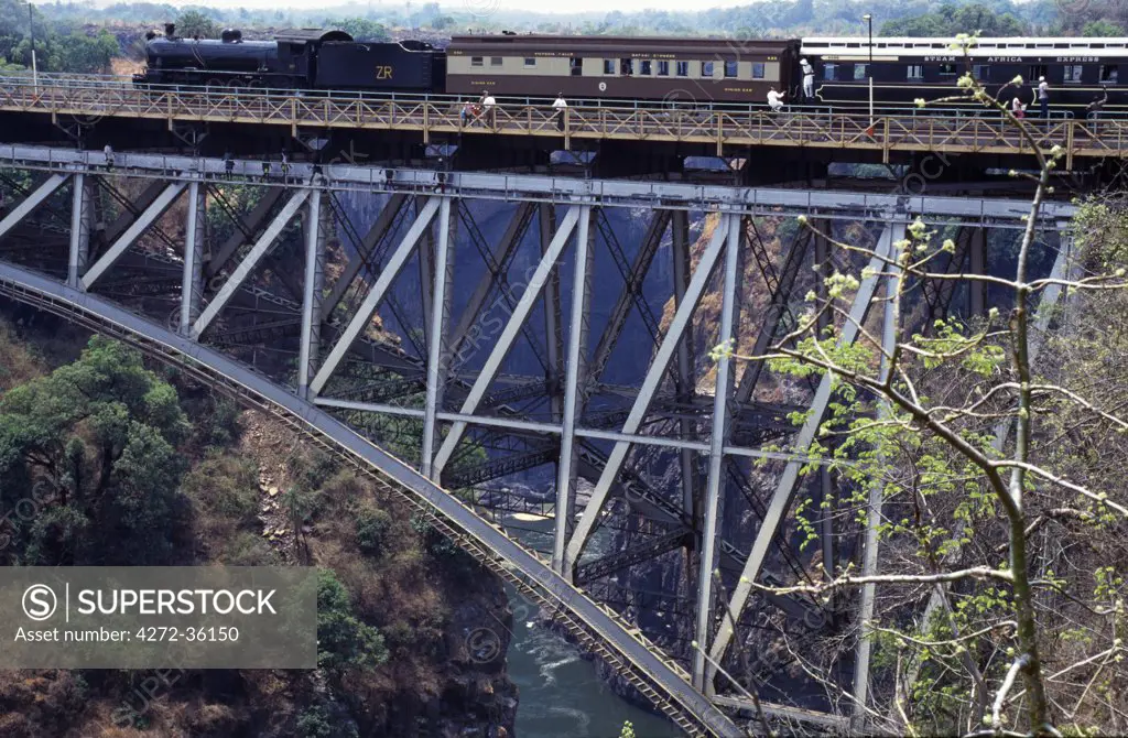 Steam train going over Victoria falls suspension bridge.