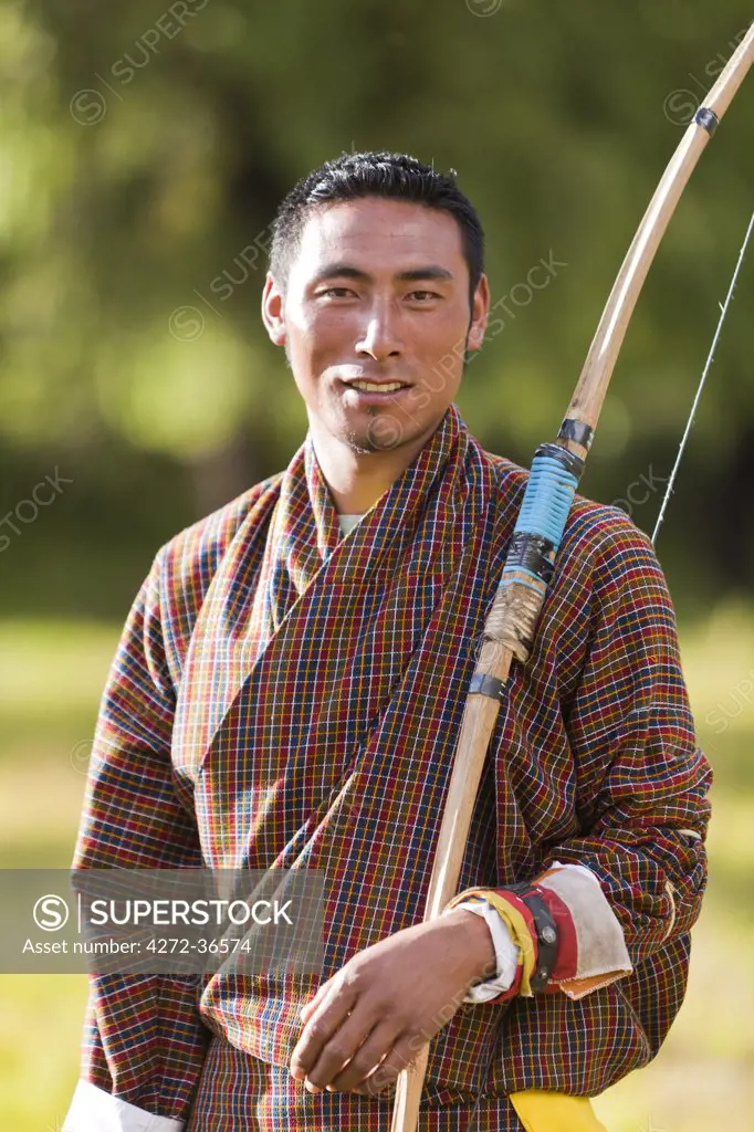 A handsome archer with traditional bamboo bow and arrow.