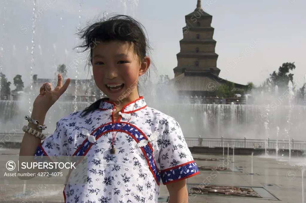 A young girl enjoying the water show at the Big Goose Pagoda Park, built in 652 by Emperor Gaozong, Xian City, Shaanxi Province, China