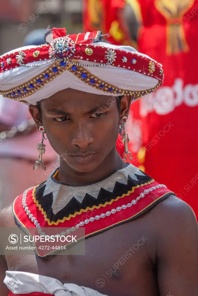 A Kandyan drummer dressed in traditional attire ready to participate in the annual Kandy Perahera, Sri Lanka