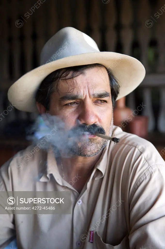 South America, Brazil, Goias, Pirenopolis, a man smoking a Corn Husk Cigarette in the Fazenda Babilonia sugar mill near Pirenopolis, PR, MR