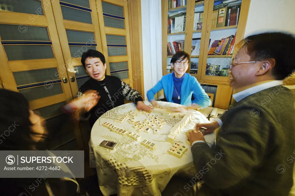 China, Beijing. Chinese New Year Spring Festival - a family playing mahjong on the Eve of New Year.