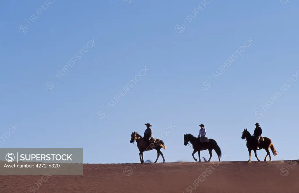 Chile, Atacama Desert. Horse riding in the Atacama desert.