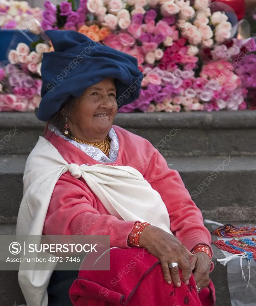 Ecuador, An indigenous Indian woman sells fresh-cut roses at the weekly Sangolqui market.