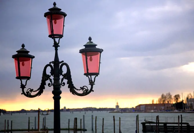 Italy, Veneto, Venice; A nicely ornamented lamp post facing the lagoon on the Bacino San Marco