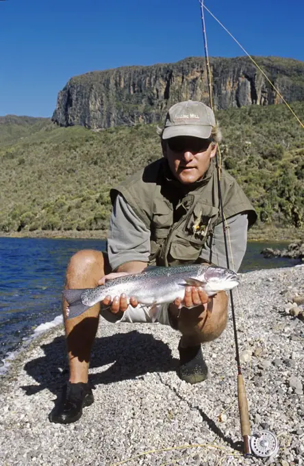 Kenya; Mount Kenya.   Erik van Vliet, Vice Chairman of Kenya Flyfishers Club with a nice rainbow trout on Lake Alice.