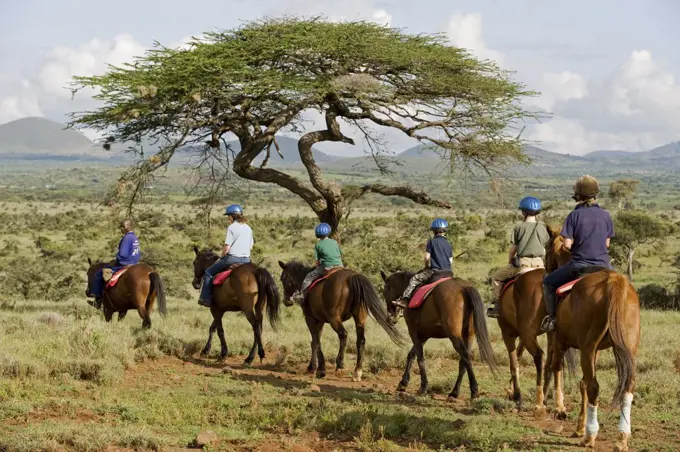 Kenya, Laikipia, Lewa Downs.  A family on a horse riding safari.