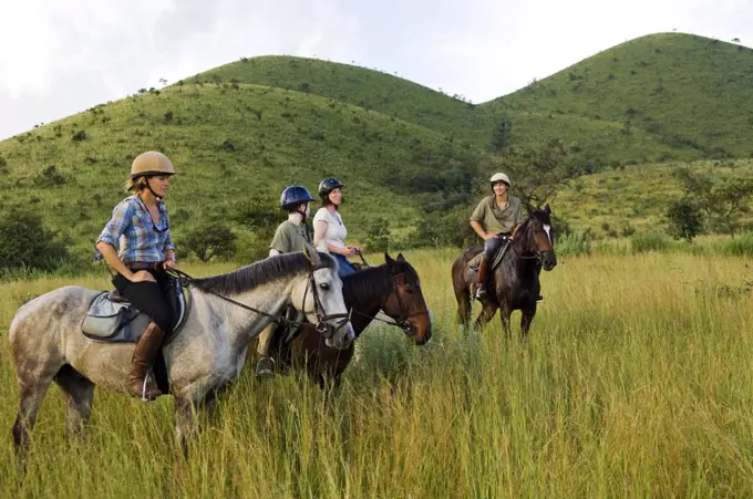 Kenya, Chyulu Hills, Ol Donyo Wuas.  A family on a horse riding safari up in the Chyulu Hills.  (MR)