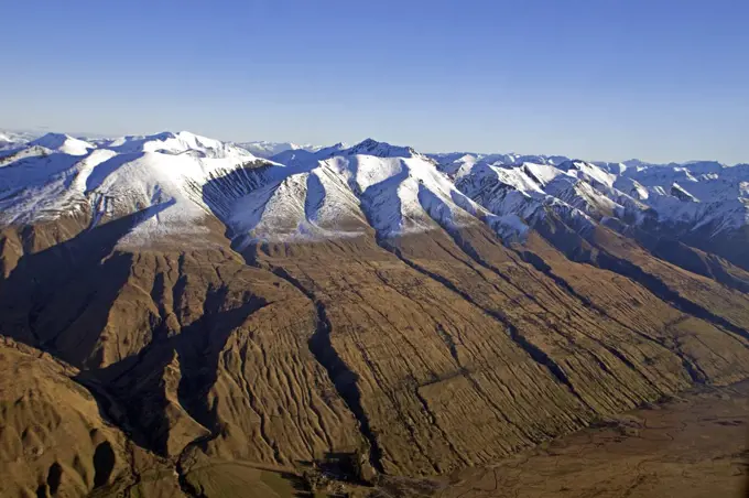 New Zealand, South Island, Christchurch.   Flying over the Southern Alps bordering the Canterbury Plains at the start of winter.