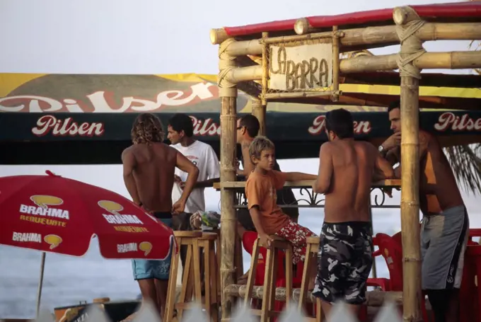 Tourists relax at a beachside bar at the resort town of Mancora, in northern Peru.