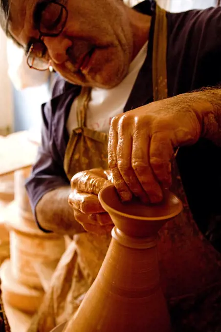 Portugal, Alentejo, Estremoz. A Portuguese potter at work in his studio in the Alentejo region of Portugal which is famous for its ceramics.